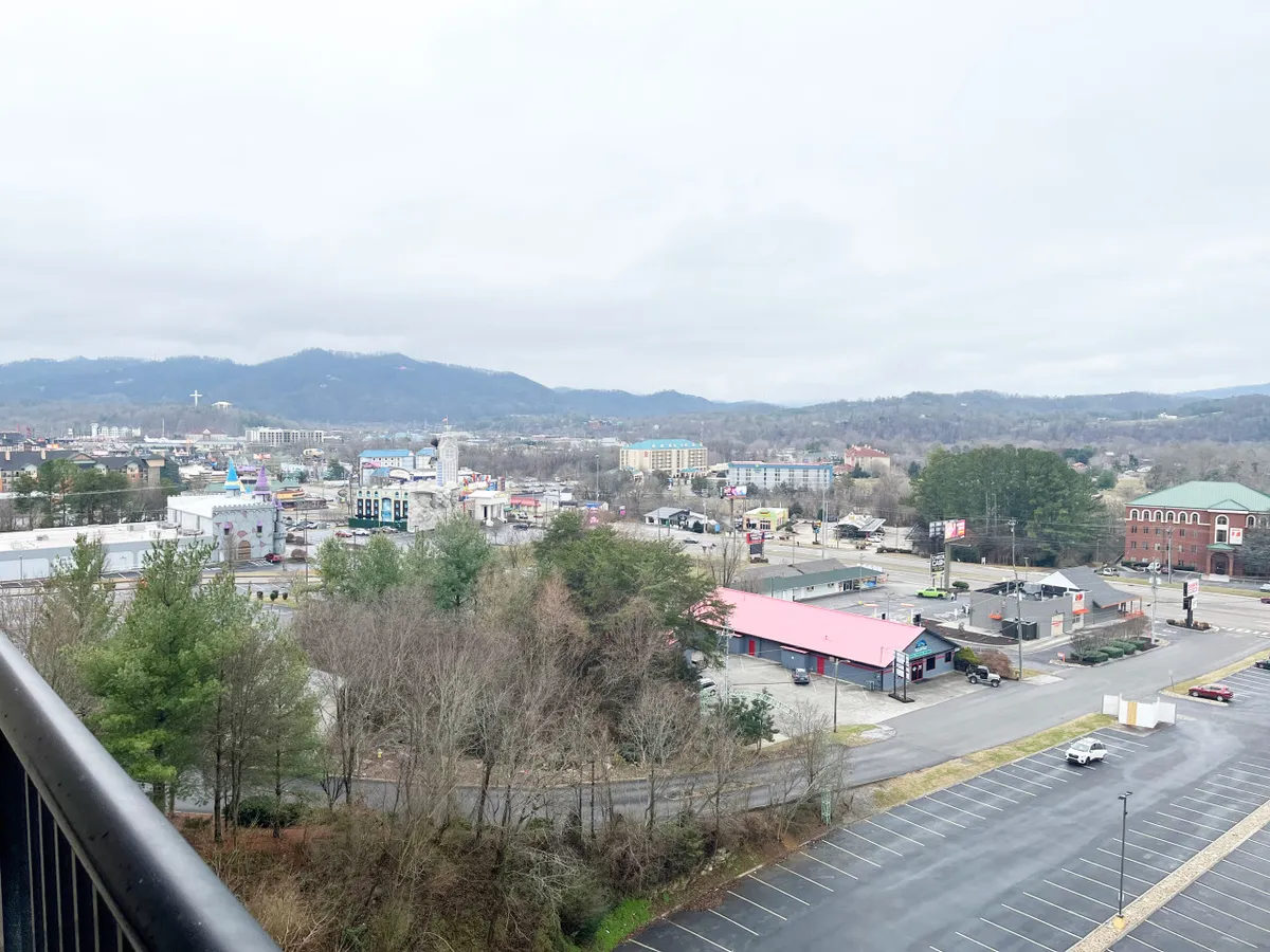 This image features a panoramic view from the resort, with the mountains and town below. The vibrant scene hints at nearby attractions and the excitement of exploring Pigeon Forge, connecting the on-property experience to local adventures just a short ride away.